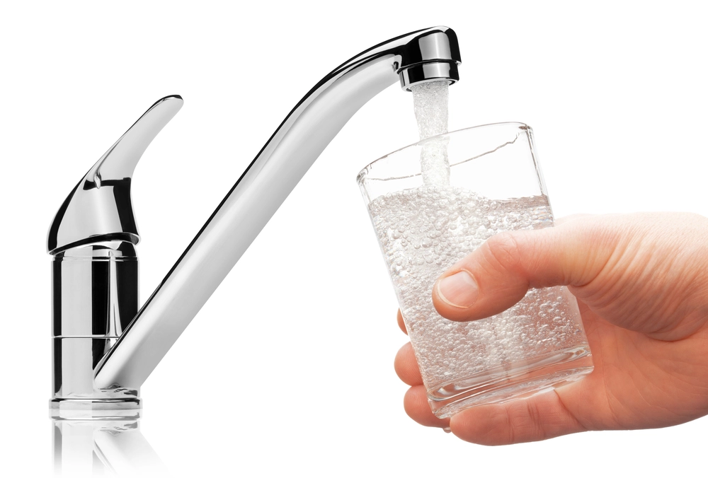 what makes hard water hard - glass filling up with water at faucet