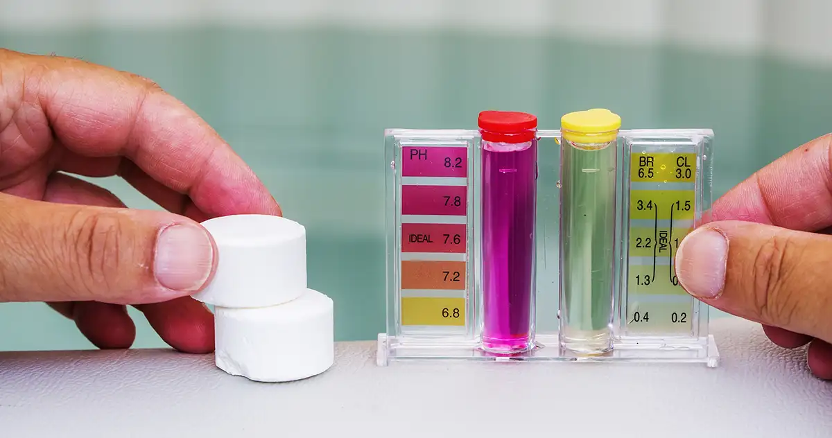 Do water filtration systems remove chlorine? A chlorine testing kit is shown with two large chlorine tabs and colorful pink and yellow tubes and measurement indicators.