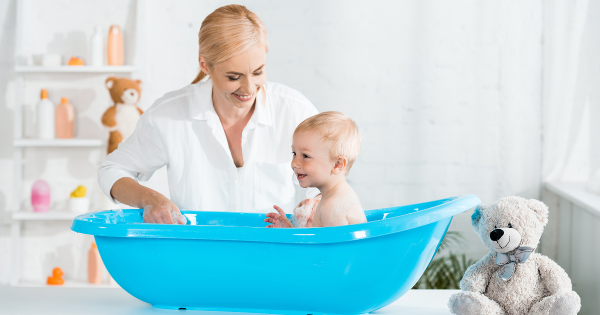 What is a water softener? Happy woman bathing smiling baby