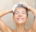 Does hard water cause hair loss? A woman washes her hair in the shower.