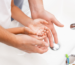 What makes hard water hard - parent and child washing hands at sink faucet